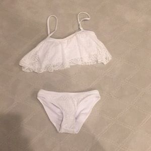 Two piece white lace swim suit never worn.